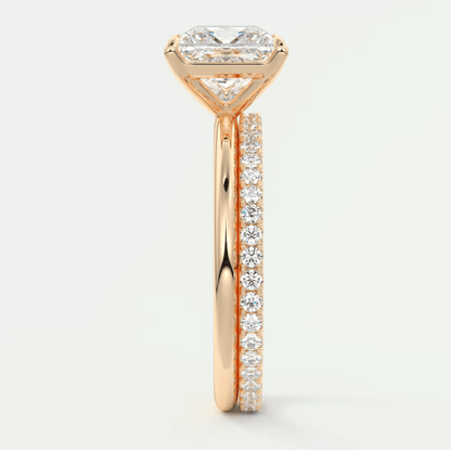 18k rose gold engagement ring with a princess cut diamond and pavé side stones.