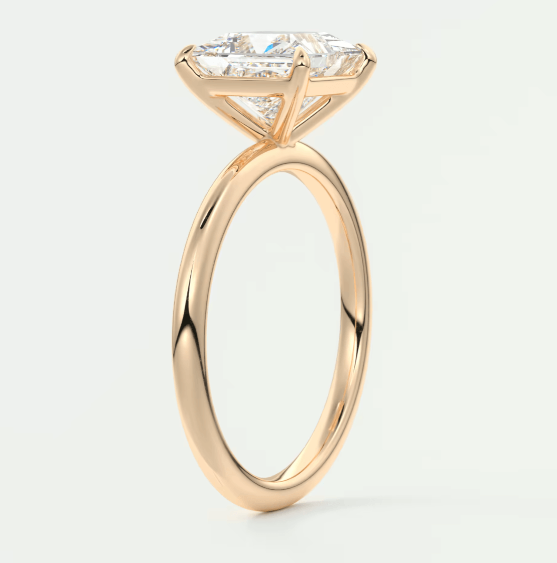 18k rose gold engagement ring with a princess cut diamond.