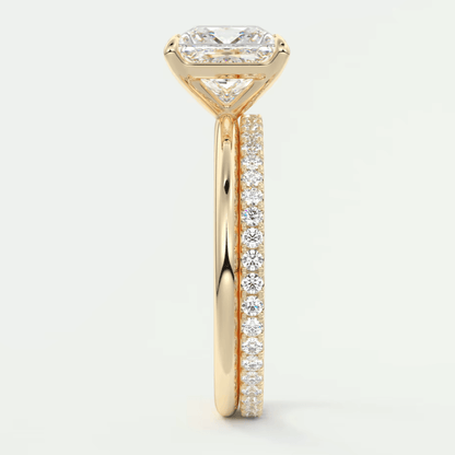 18k yellow gold engagement ring with princess cut diamond and pave set diamonds on the band.