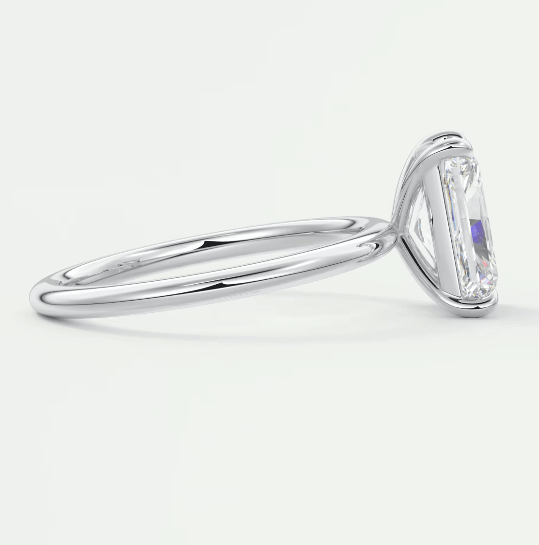 18k white gold engagement ring with a rectangular diamond.