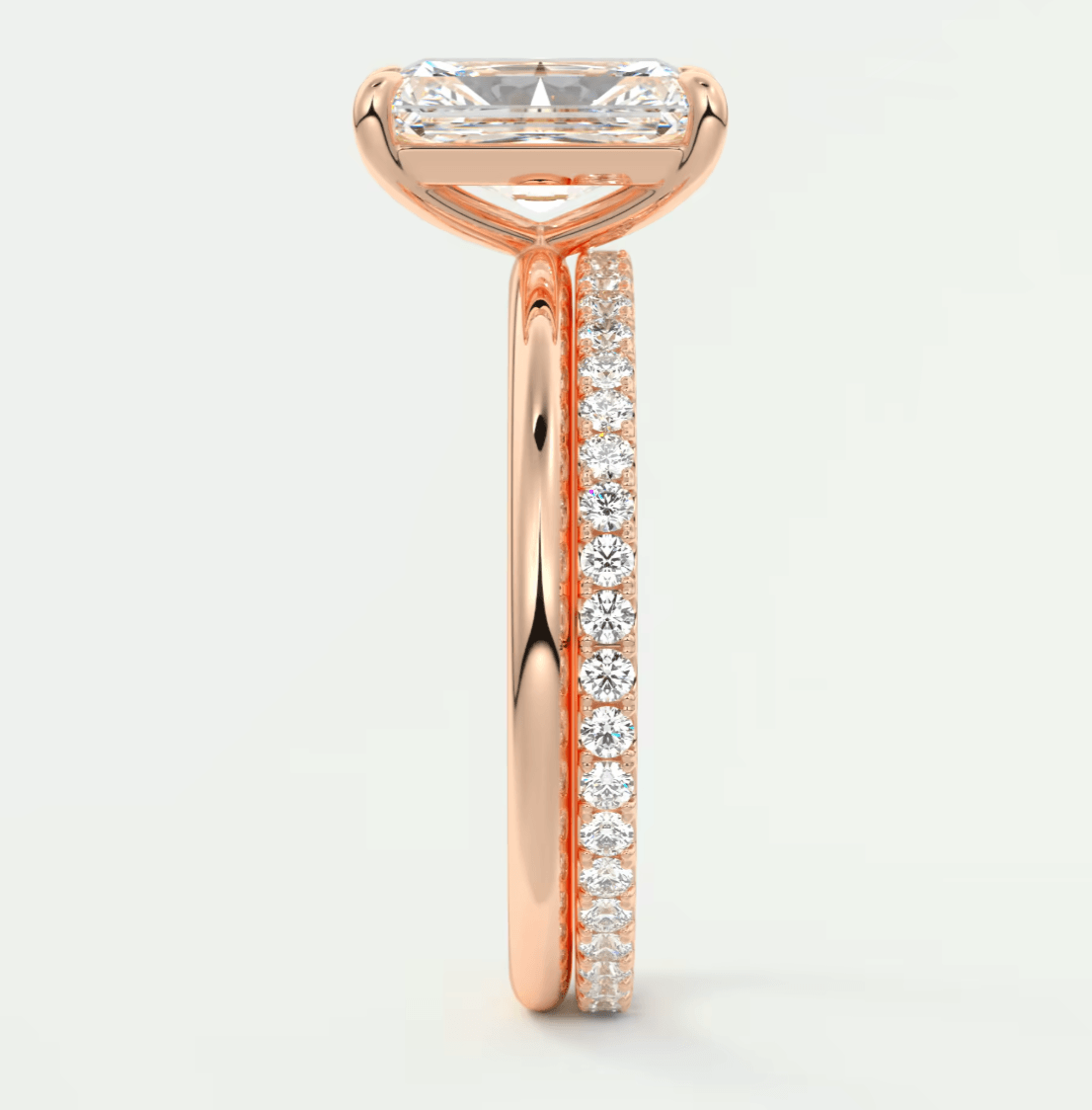 Rose gold diamond engagement ring with a princess cut center stone and channel set diamonds on the band.