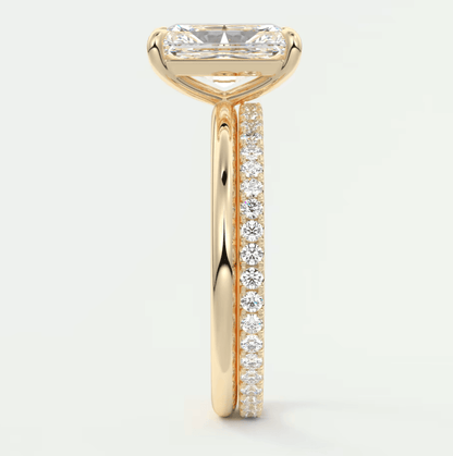 18k yellow gold engagement ring with a princess cut diamond and pavé side stones.