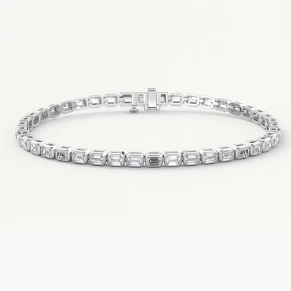 A white gold tennis bracelet featuring a row of baguette-cut clear gemstones in a continuous link design, displayed on a clean white background.