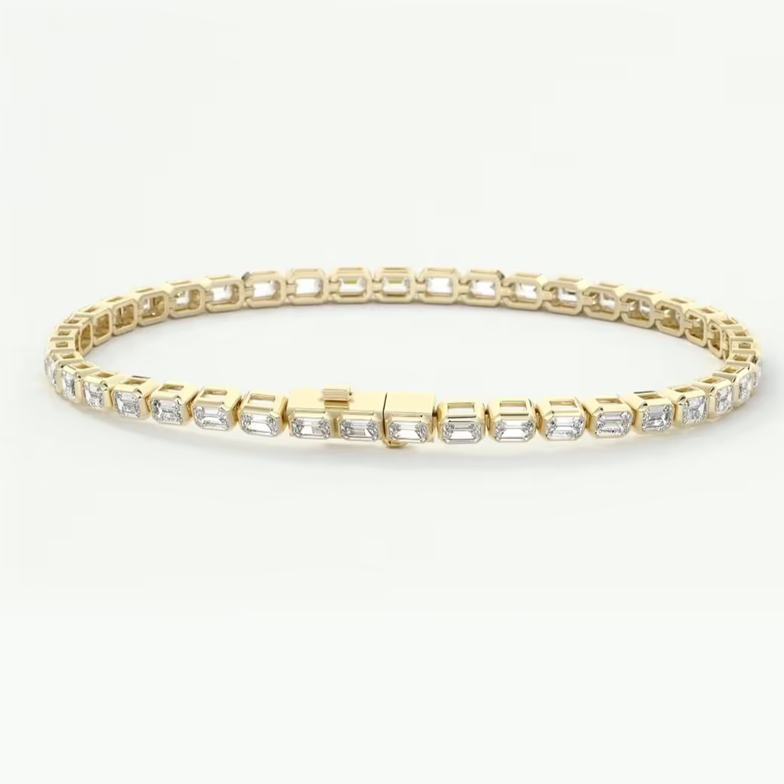 A yellow gold tennis bracelet featuring a row of clear rectangular baguette-cut gemstones, displayed against a clean white background.
