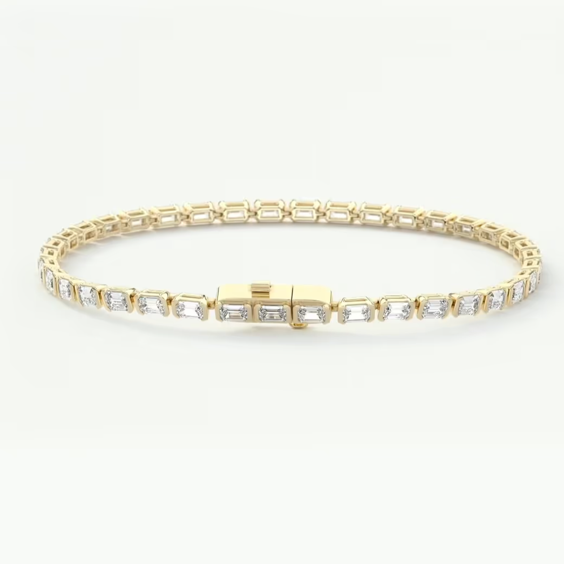 A yellow gold tennis bracelet featuring rectangular baguette-cut clear stones, displayed on a clean white background.