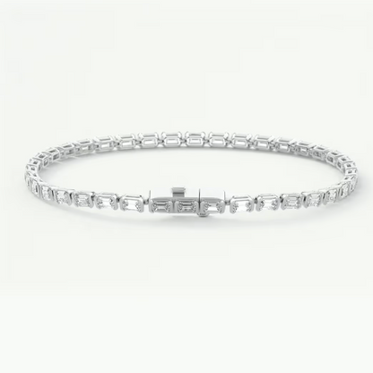 A silver tennis bracelet with rectangular baguette-cut stones, displayed in a circular shape against a clean white background.