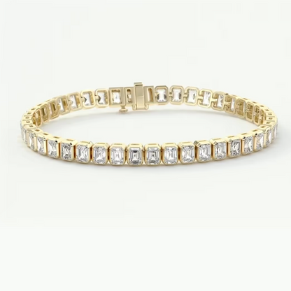 A yellow gold tennis bracelet featuring a continuous row of baguette-cut clear gemstones in a prong setting, displayed on a clean white background.