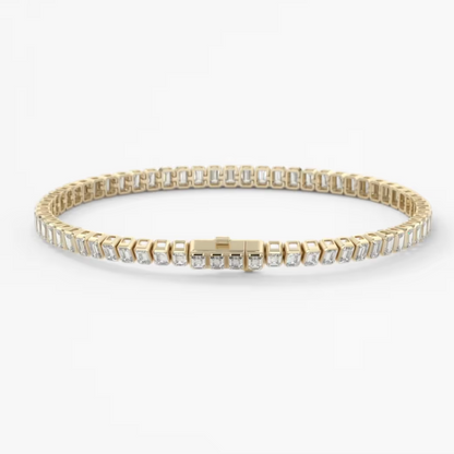 A gold tennis bracelet with clear rectangular-cut stones, displayed on a clean white background.
