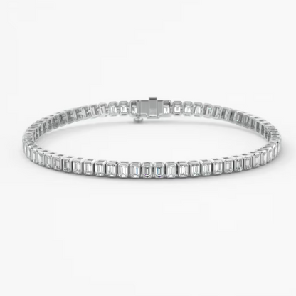 A white gold tennis bracelet featuring baguette-cut clear stones in a continuous link design, displayed on a clean white background.