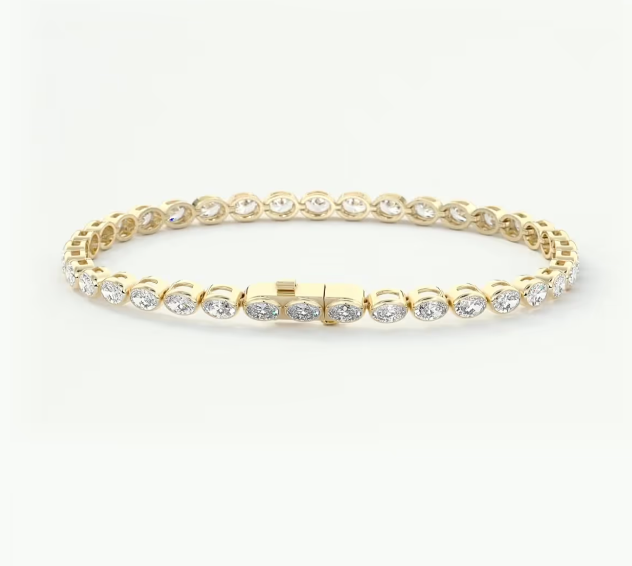 A yellow gold tennis bracelet with round-cut clear stones set in a continuous circle, displayed on a clean white background.