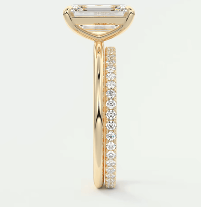 18k yellow gold engagement ring with a princess cut diamond and pave set diamonds on the band.