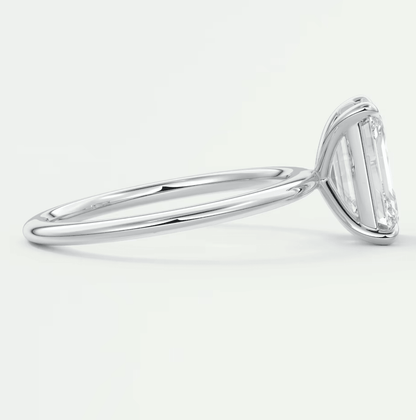 18k white gold solitaire engagement ring with a baguette diamond.