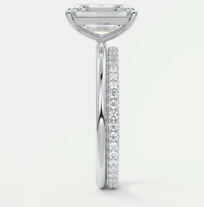 18k white gold diamond engagement ring with a princess cut center stone and pave set diamonds on the band.
