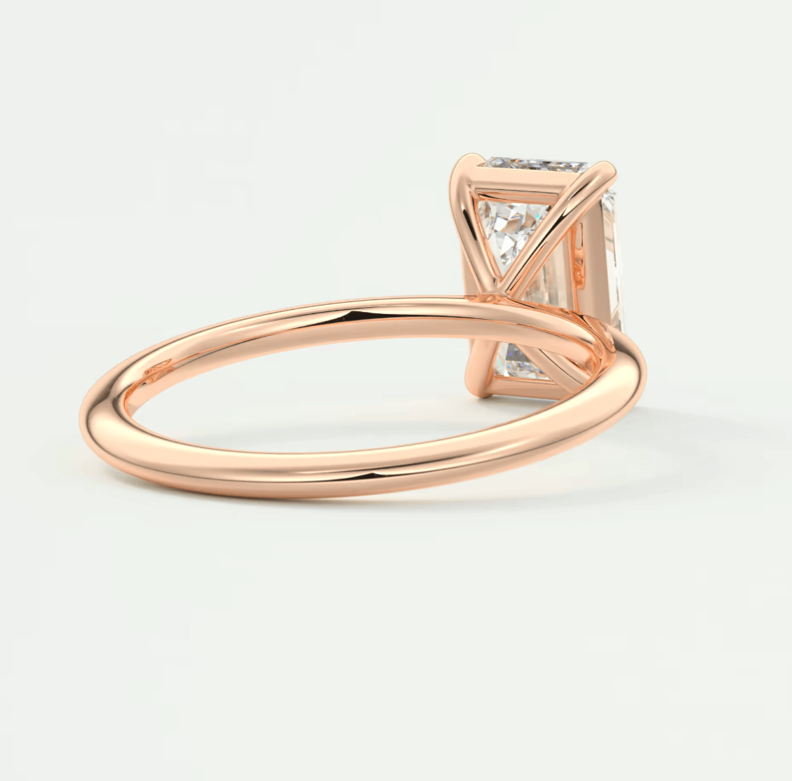 18k rose gold princess cut diamond engagement ring with white diamonds on the band.