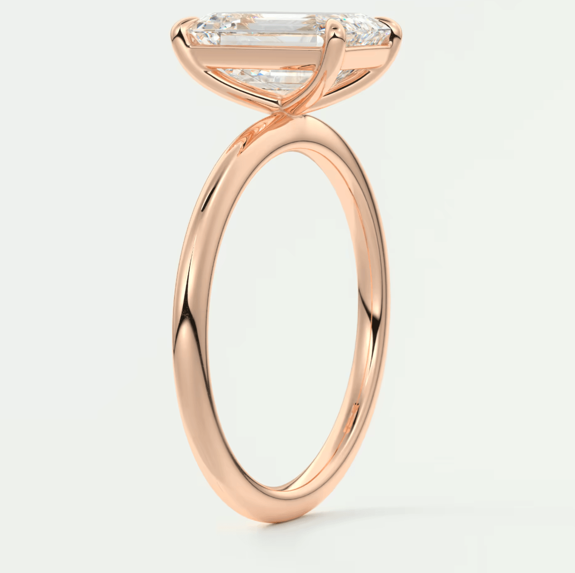 Rose gold engagement ring with a marquise-cut diamond and smaller diamonds on the band.