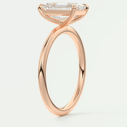 Rose gold engagement ring with a marquise-cut diamond and smaller diamonds on the band.