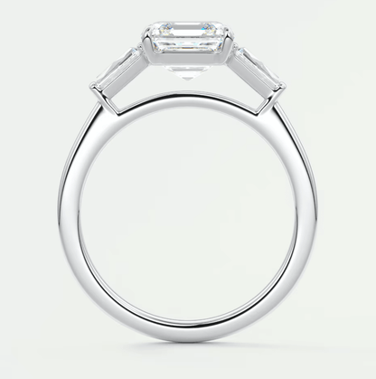 18k white gold emerald-cut diamond engagement ring with baguette accents.