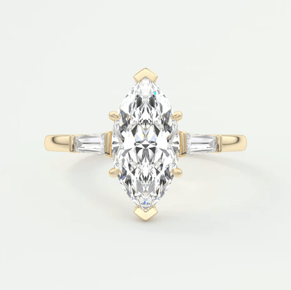 18-karat yellow gold marquise-cut diamond engagement ring with baguette side stones.