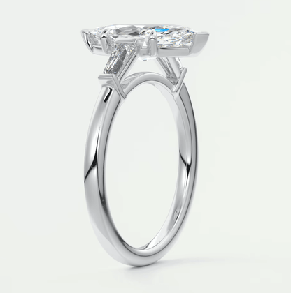 18-karat white gold engagement ring with a cushion-cut diamond center stone and baguette diamonds on the band.