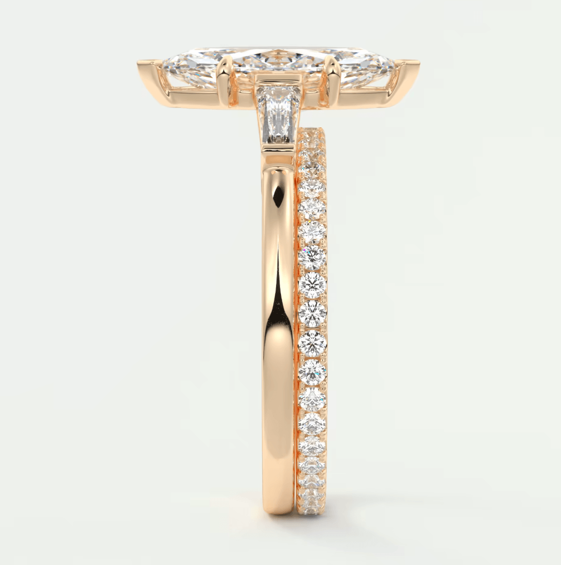 18k rose gold diamond engagement ring with a marquise-cut center stone and pavé side stones.