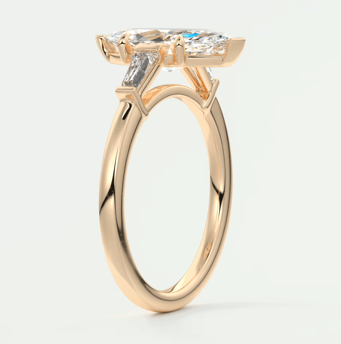 18-karat gold engagement ring with a cushion-cut diamond and baguette diamonds, featuring a classic solitaire design.