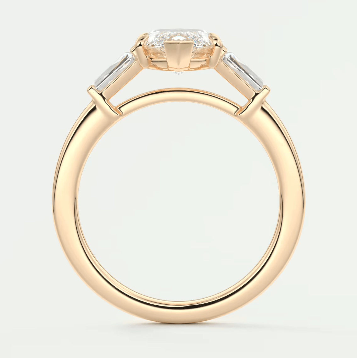 18k yellow gold engagement ring with three baguette diamonds.