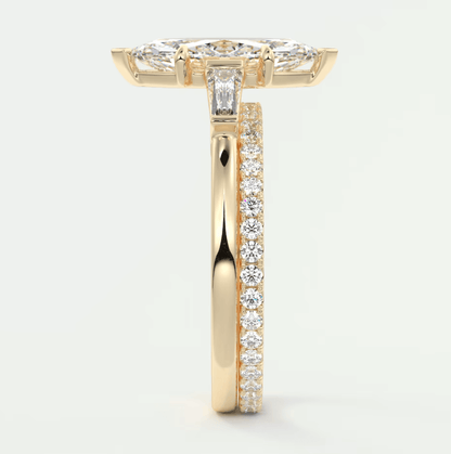 18k yellow gold diamond engagement ring with a marquise-shaped center stone and channel-set diamonds on the band.