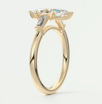18k yellow gold engagement ring with a cushion-cut diamond and two trapezoid diamonds, featuring an elegant design.