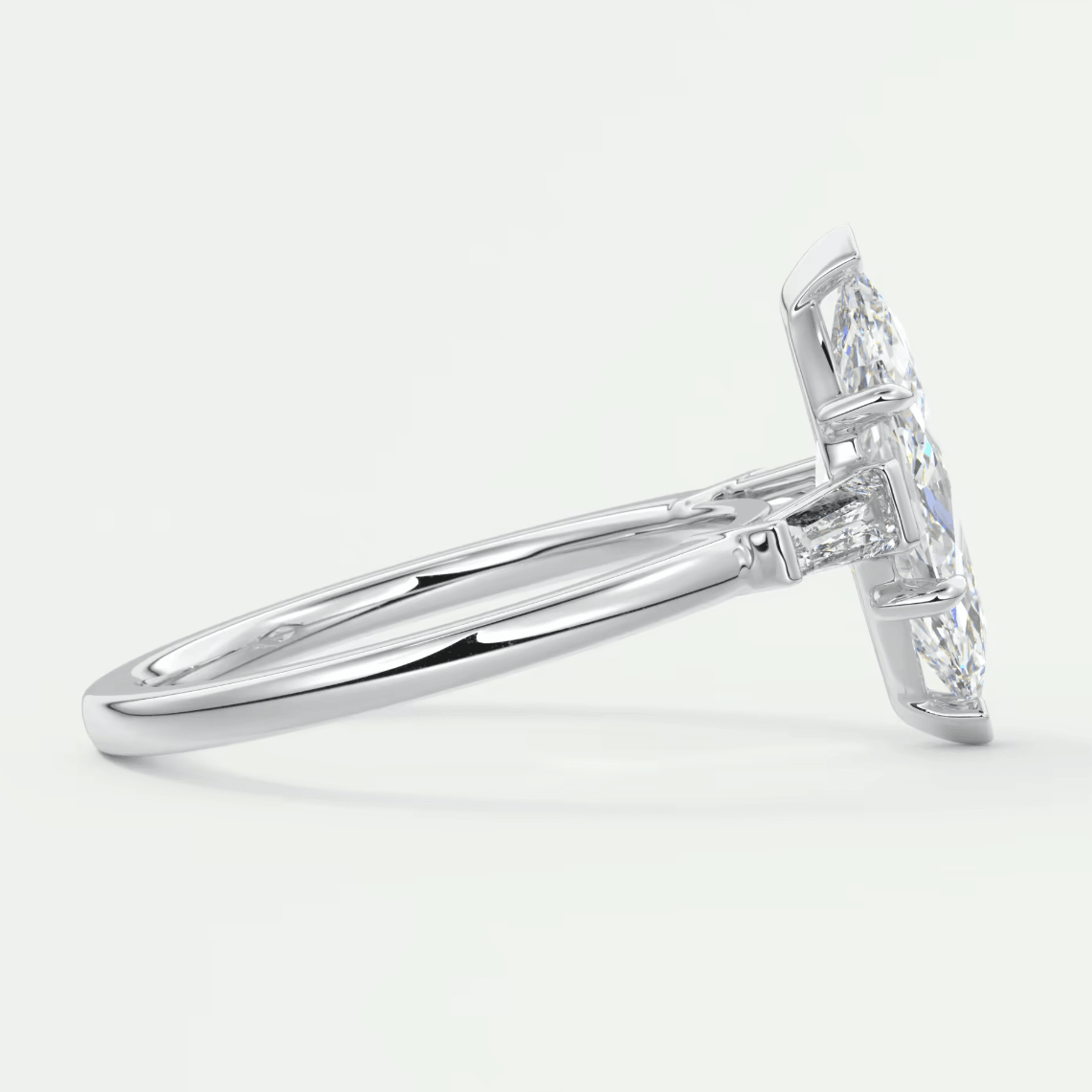 White gold diamond engagement ring with a princess cut center stone and baguette side stones.
