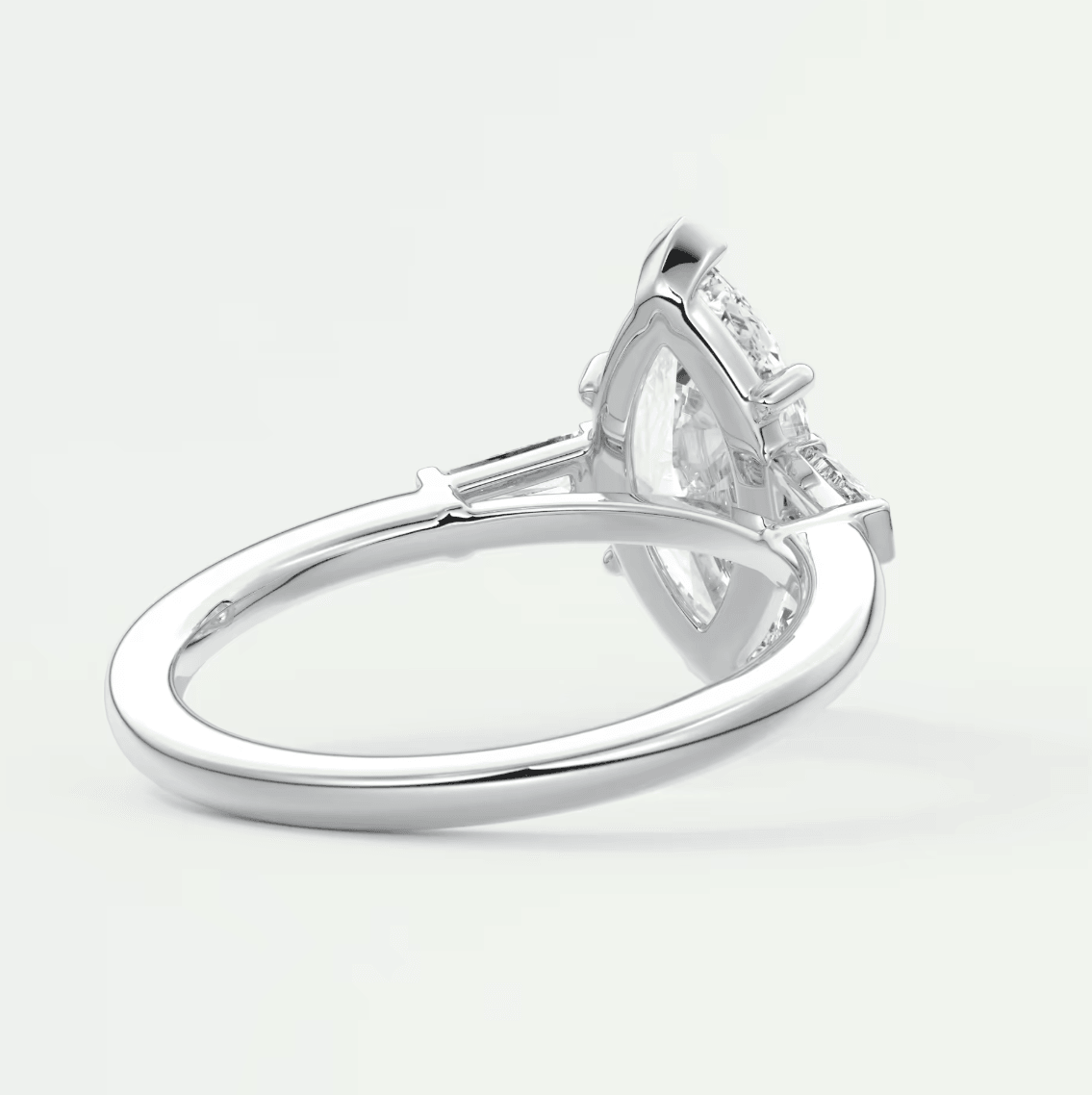 Silver diamond engagement ring with a marquise-cut center stone and small side diamonds.