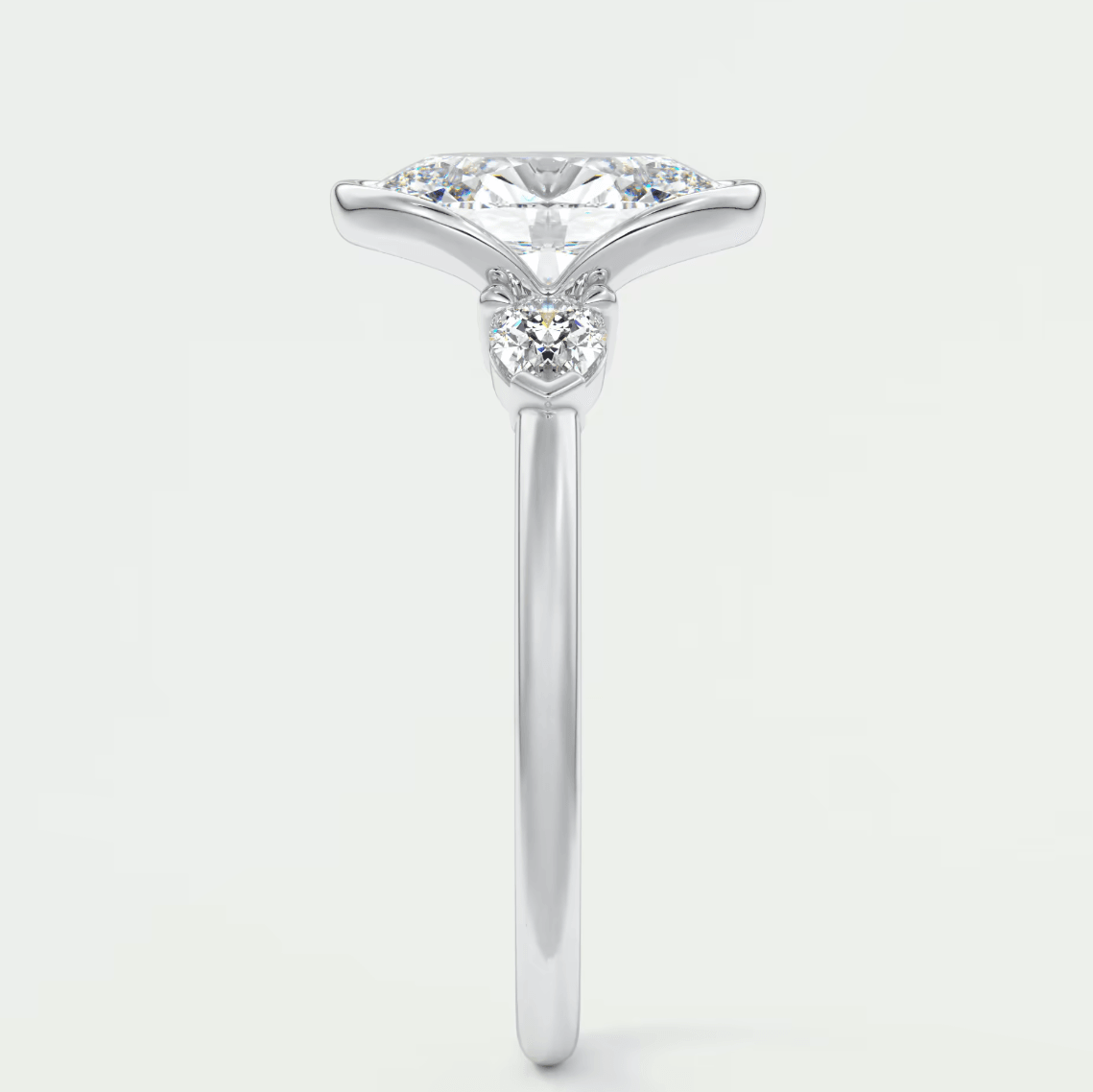 18k white gold engagement ring with a princess cut diamond and three smaller diamonds on the band.