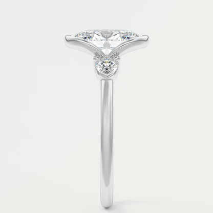 18k white gold engagement ring with a princess cut diamond and three smaller diamonds on the band.
