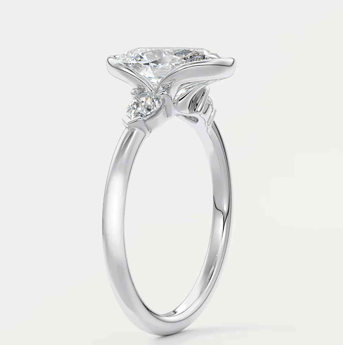 Silver diamond engagement ring with a marquise-cut center stone and small round diamonds set in the band.