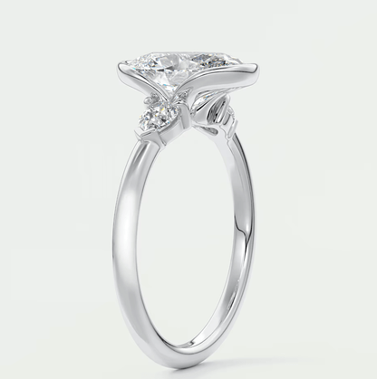 Silver diamond engagement ring with a marquise-cut center stone and small round diamonds set in the band.