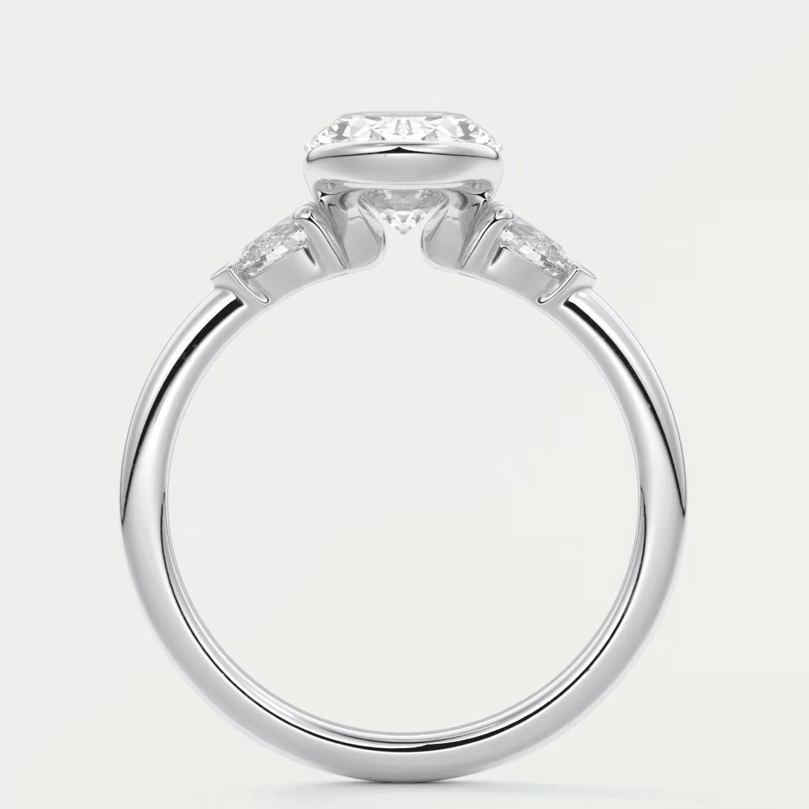 White gold engagement ring with a cushion-cut diamond and two smaller diamonds on each side.