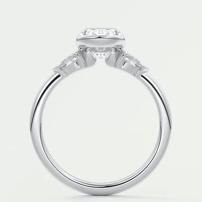 White gold engagement ring with a cushion-cut diamond and two smaller diamonds on each side.