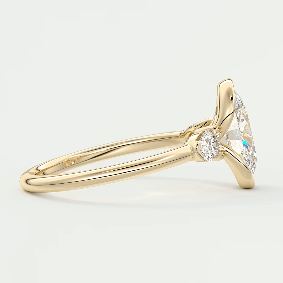 18k yellow gold diamond engagement ring with a marquise-cut center stone and small round diamonds on the band.