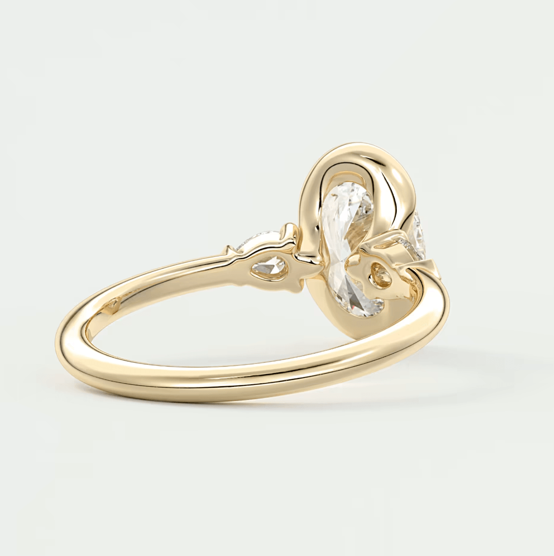 18k gold engagement ring with a pear-shaped diamond.