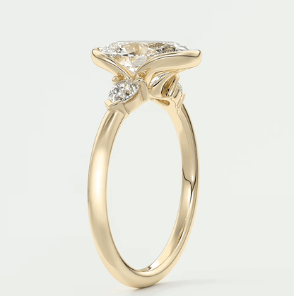 18-karat yellow gold engagement ring with a princess-cut diamond and two smaller diamonds set in the band.