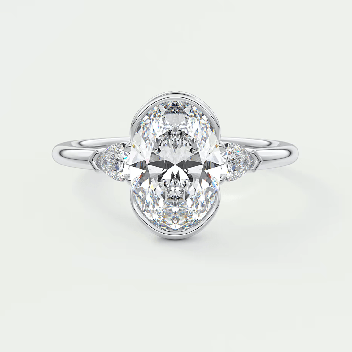 18k white gold engagement ring with an oval diamond center stone and marquise side stones.