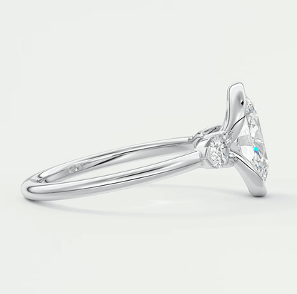 18k white gold diamond engagement ring with a marquise-cut center stone and small diamonds on the band.