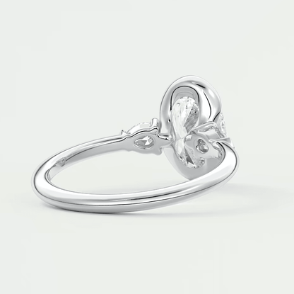 Silver knot engagement ring with a clear gemstone center.
