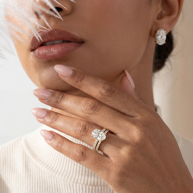 Close-up of a woman's hand wearing a diamond ring with a blurred background