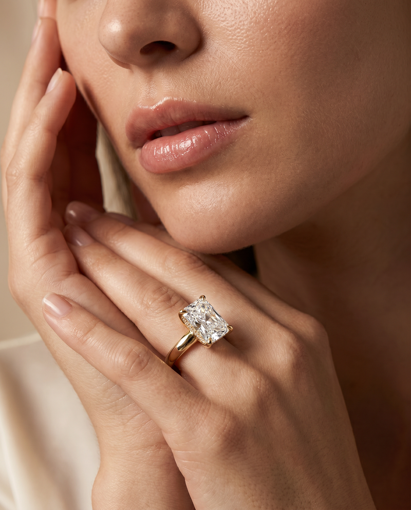 Close-up of a hand wearing a diamond ring with a blurred background