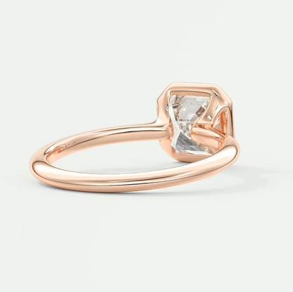 Rose gold engagement ring with a large, octagonal diamond center stone.