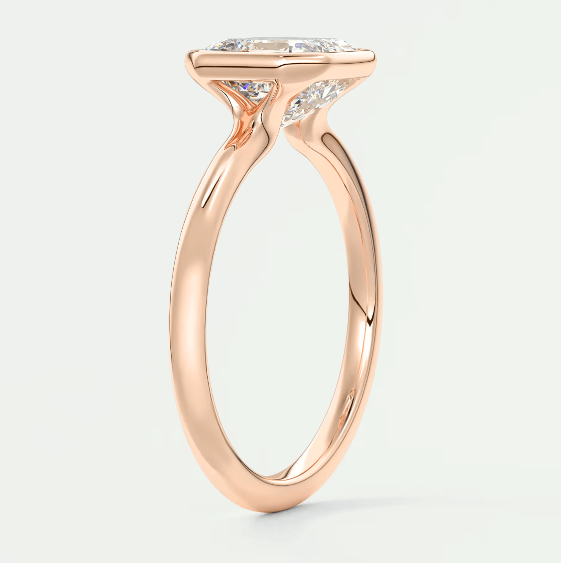 Rose gold engagement ring with a princess cut diamond.