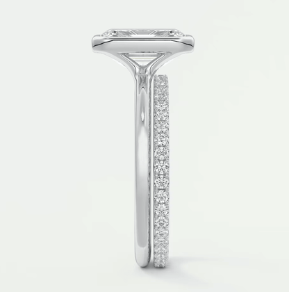 18k white gold diamond engagement ring with a princess cut center stone and channel set diamonds on the band.