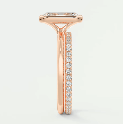Rose gold diamond engagement ring with a princess cut center stone and channel set side stones.