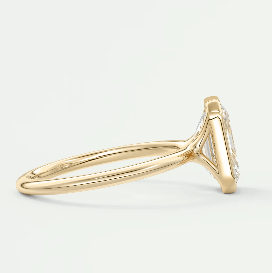 18k yellow gold diamond engagement ring with a marquise-cut center stone and small diamonds on the band.