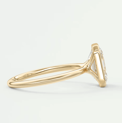 18k yellow gold diamond engagement ring with a marquise-cut center stone and small diamonds on the band.